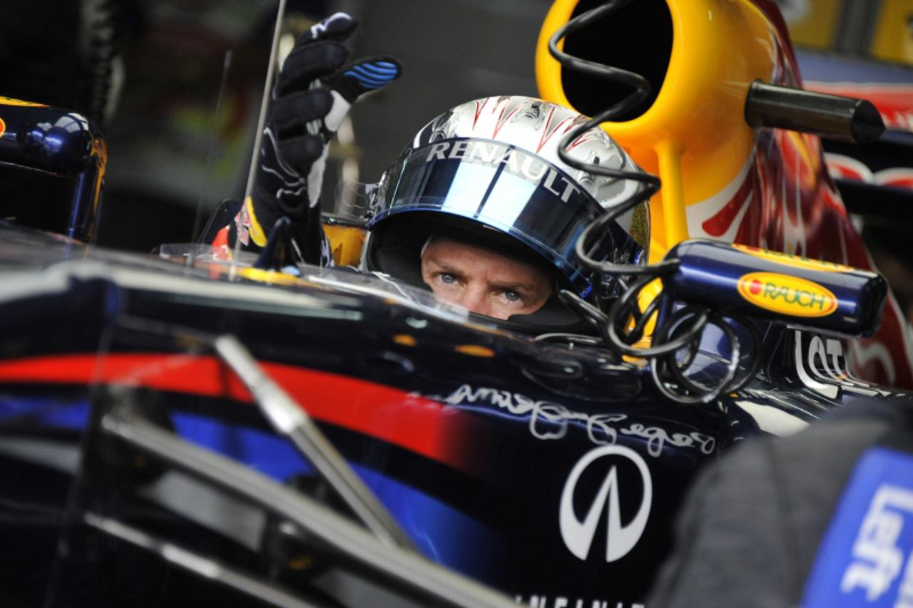 'Red Bull-Renault driver Sebastian Vettel of Germany prepares to take off from the pit for the third practice session for Formula One\'s Malaysian Grand Prix at Sepang on April 9, 2011.  AFP PHOTO / R