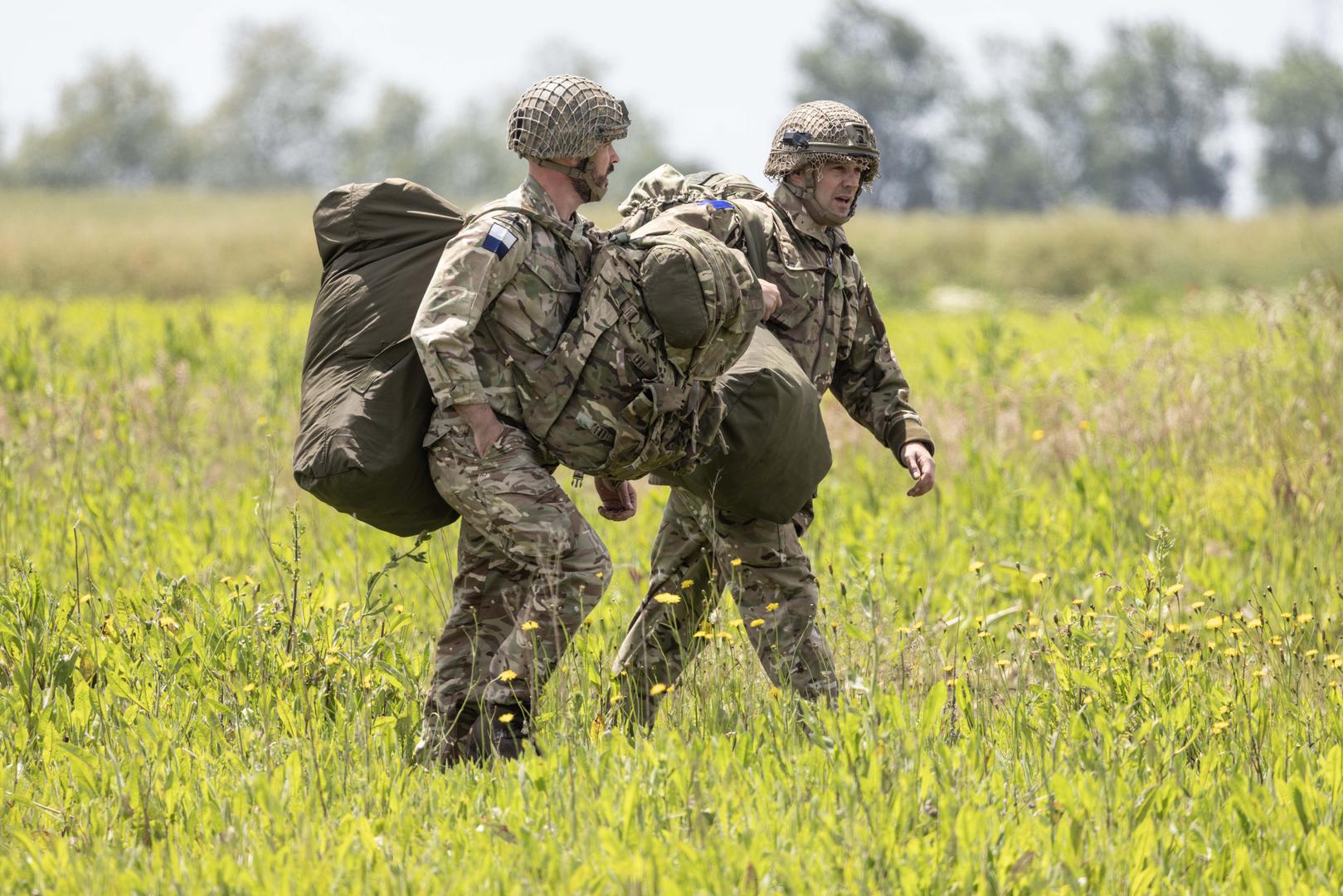 Paratroopers land in a field after making a commemorative jump into fields around the French village of Sanneville in Normandy as part of the 80th anniversary of D-day. 05.06.2024   Material must be credited "The Times/News Licensing" unless otherwise agreed. 100% surcharge if not credited. Online rights need to be cleared separately. Strictly one time use only subject to agreement with News Licensing Photo: Richard Pohle/NEWS SYNDICATION