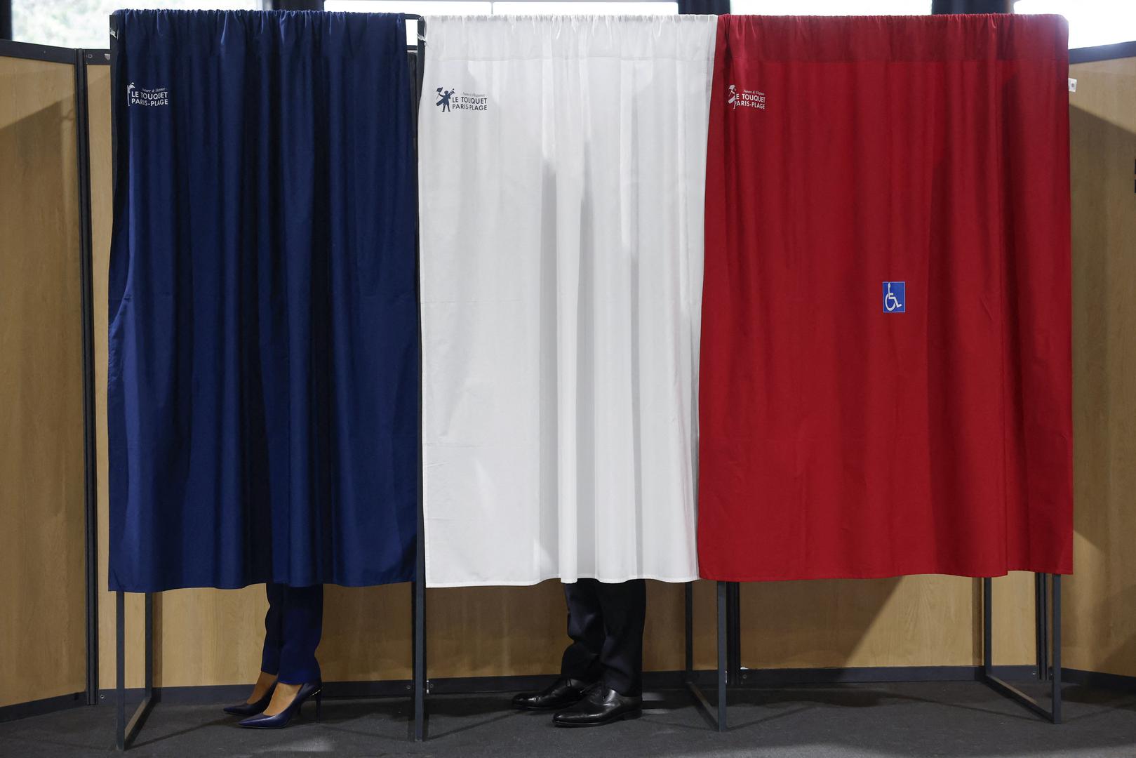 French President Emmanuel Macron (C) and French First Lady Brigitte Macron (L) vote at a polling station in the second round of French parliamentary elections in Le Touquet-Paris-Plage, France, 07 July 2024. MOHAMMED BADRA/Pool via REUTERS Photo: MOHAMMED BADRA / POOL/REUTERS