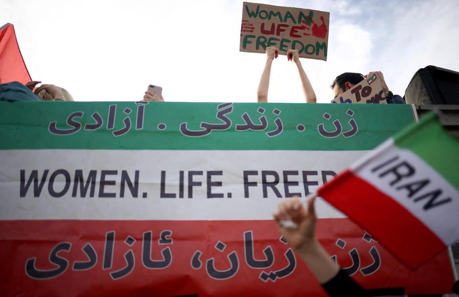 People protest following the death of Mahsa Amini, in London