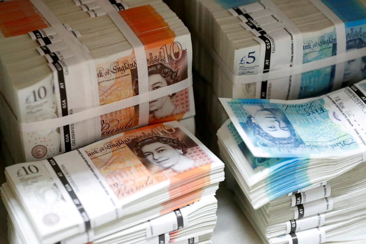 FILE PHOTO: Wads of British Pound Sterling banknotes are stacked in piles at the Money Service Austria company's headquarters in Vienna