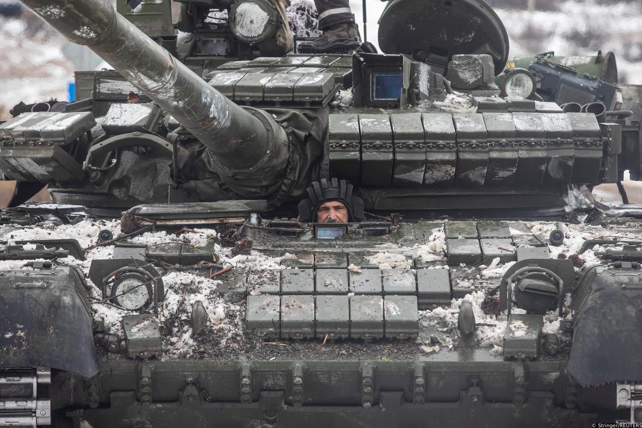 Ukrainian serviceman drives a tank along a road outside the frontline town of Bakhmut