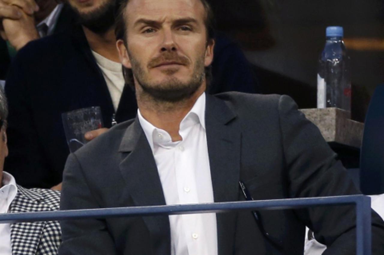 'English soccer star David Beckham watches Rafael Nadal of Spain face Novak Djokovic of Serbia in the men\'s final match at the U.S. Open tennis championships in New York, September 9, 2013.          