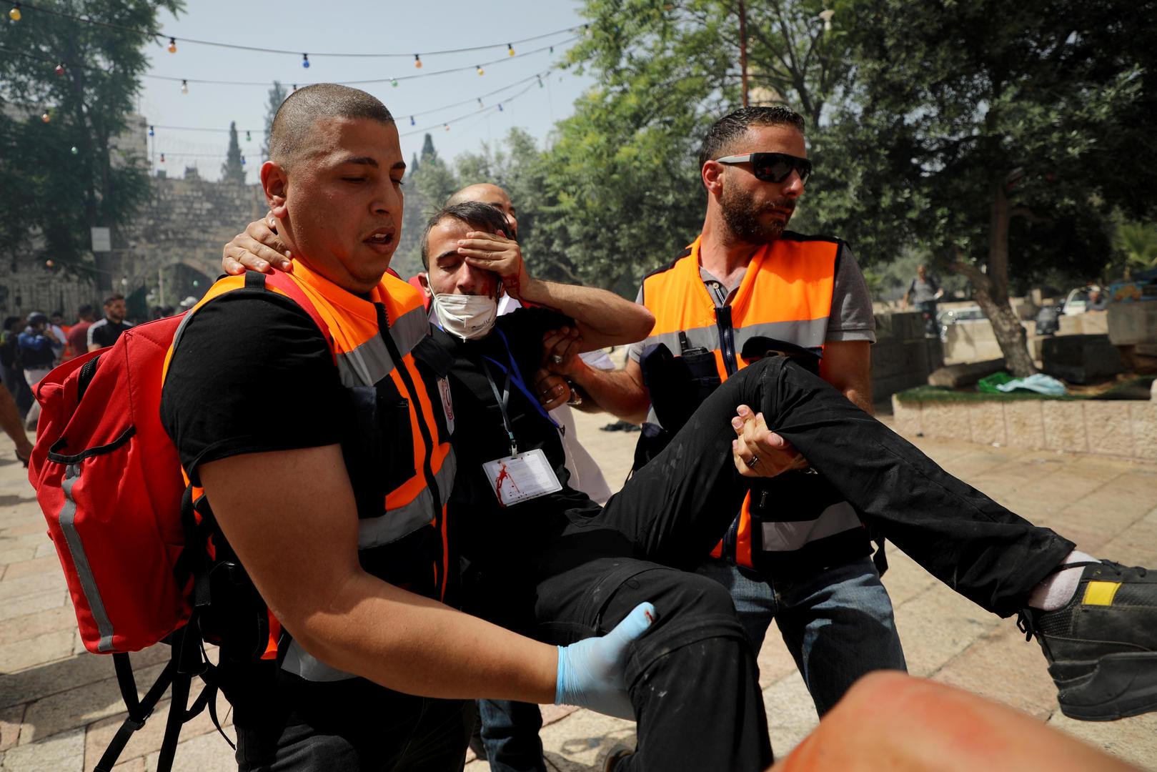 Israeli police clash with Palestinians at the compound that houses Al-Aqsa Mosque in Jerusalem A wounded Palestinian is evacuated during clashes with Israeli police at the compound that houses Al-Aqsa Mosque, known to Muslims as Noble Sanctuary and to Jews as Temple Mount, in Jerusalem's Old City, May 10, 2021. REUTERS/Ammar Awad AMMAR AWAD