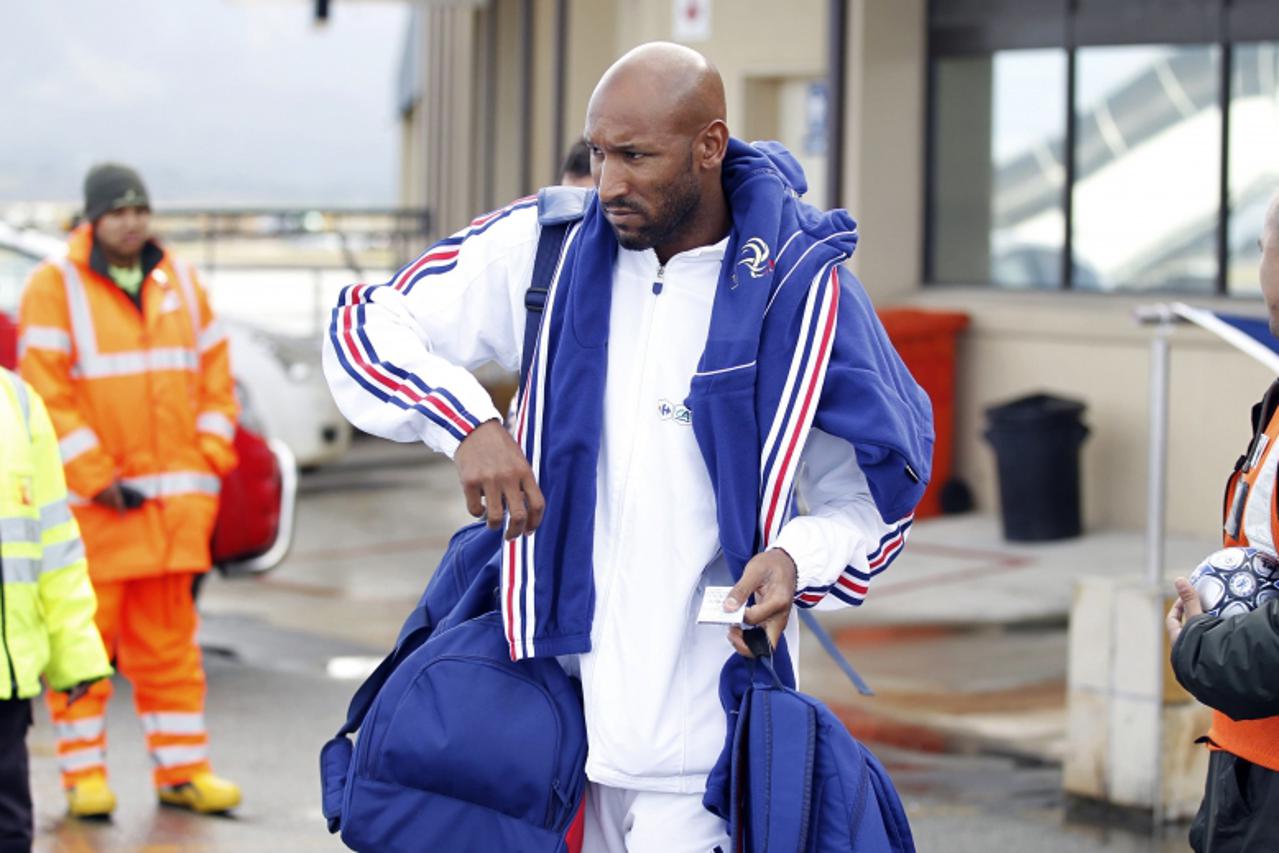 'France\'s national soccer team striker Nicolas Anelka leaves George airport, near Cape Town for the match against Mexico in this June 16, 2010 file picture. A report that troubled striker Anelka had 