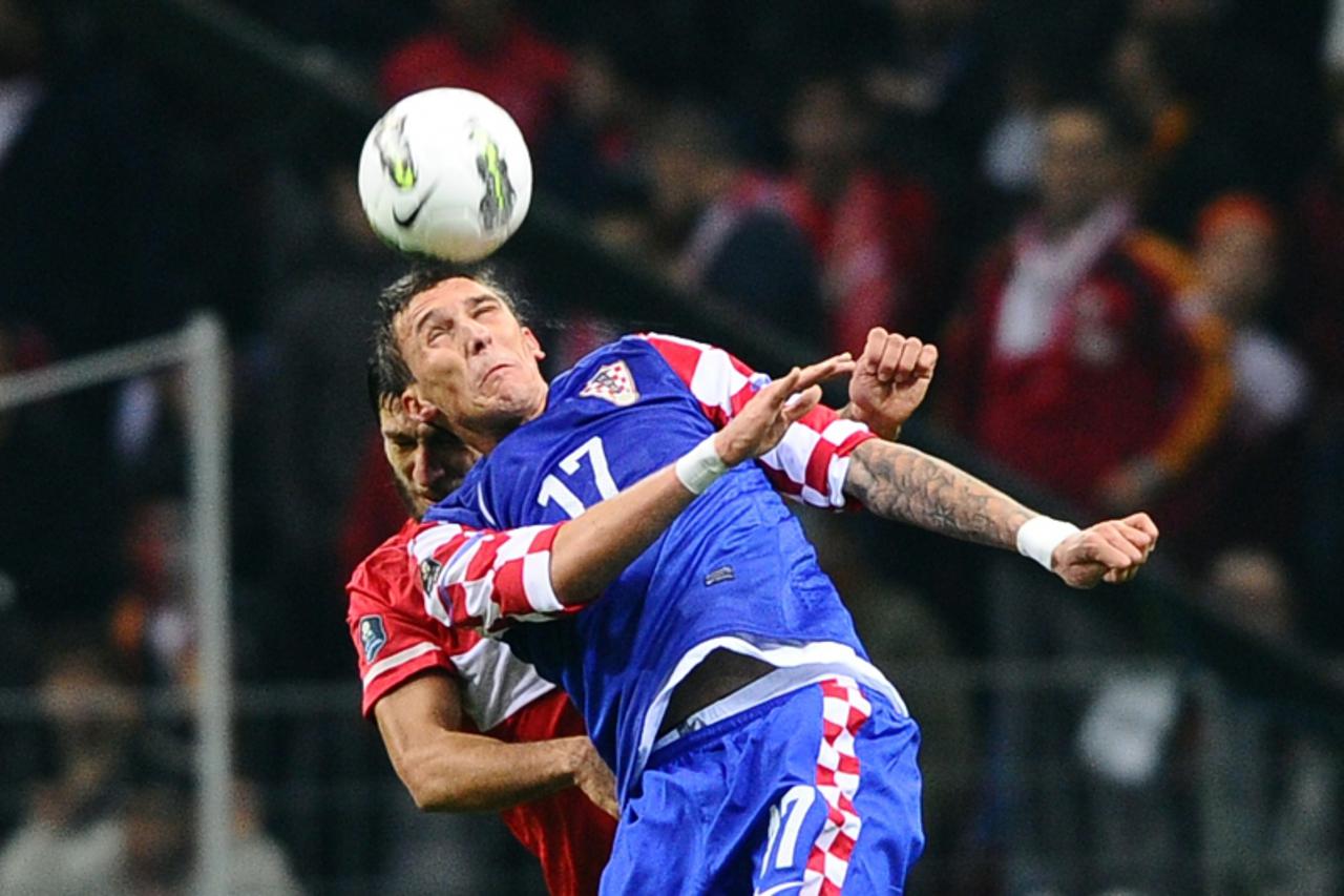 'Turkey\'s Egemen Korkmaz (L) vies with Croatia\'s Mario Mandzukic (R) during their Euro 2012 Group A play-off football match Turkey vs Croatia at the Turk Telekom Arena stadium in Istanbul, on Novemb