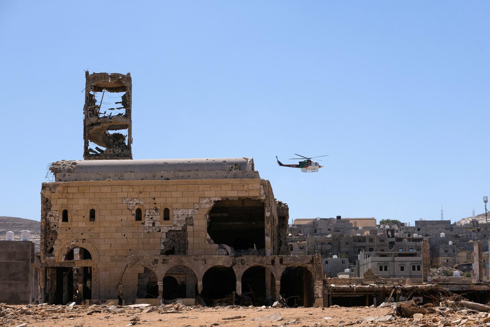 A helicopter flies over damaged buildings, after a powerful storm and heavy rainfall hit Libya, in Derna, Libya September 13, 2023. REUTERS/Esam Omran Al-Fetori Photo: ESAM OMRAN AL-FETORI/REUTERS