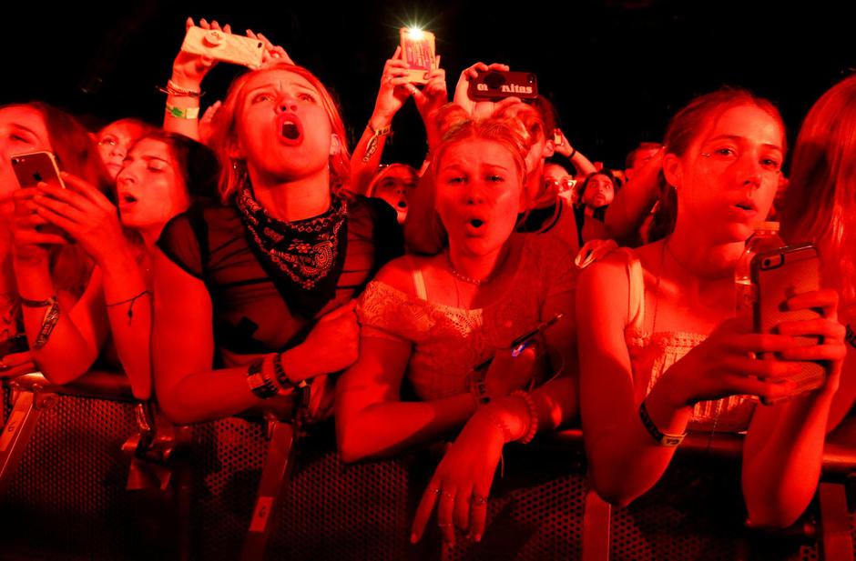 FILE PHOTO: Concertgoers watch a performance by Post Malone at the Coachella Valley Music and Arts Festival in Indio