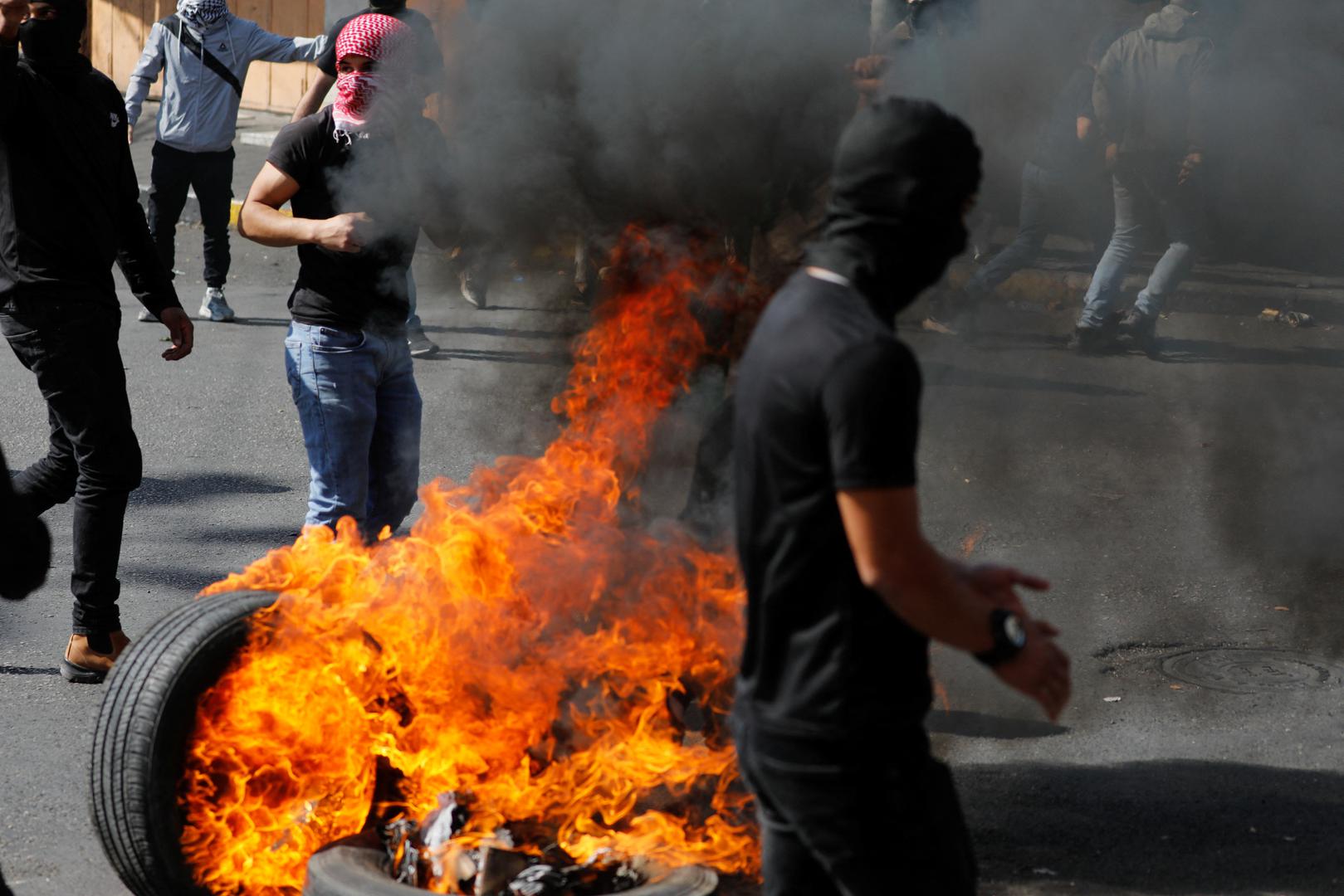 Protesters stand next to burning tires during a protest in support of the people in Gaza, after hundreds of Palestinians were killed in a blast at Al-Ahli hospital in Gaza that Israeli and Palestinian officials blamed on each other, in Hebron in the Israeli-occupied West Bank October 18,2023. REUTERS/Mussa Qawasma Photo: MUSSA ISSA QAWASMA/REUTERS