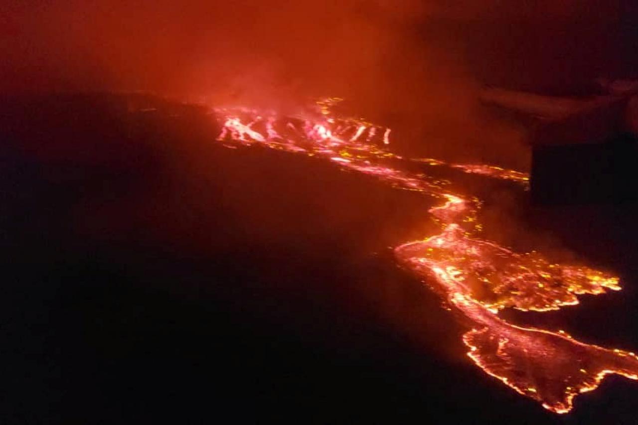 Residents pick up remains of their destroyed homes from the smouldering lava deposited by the eruption of Mount Nyiragongo volcano near Goma