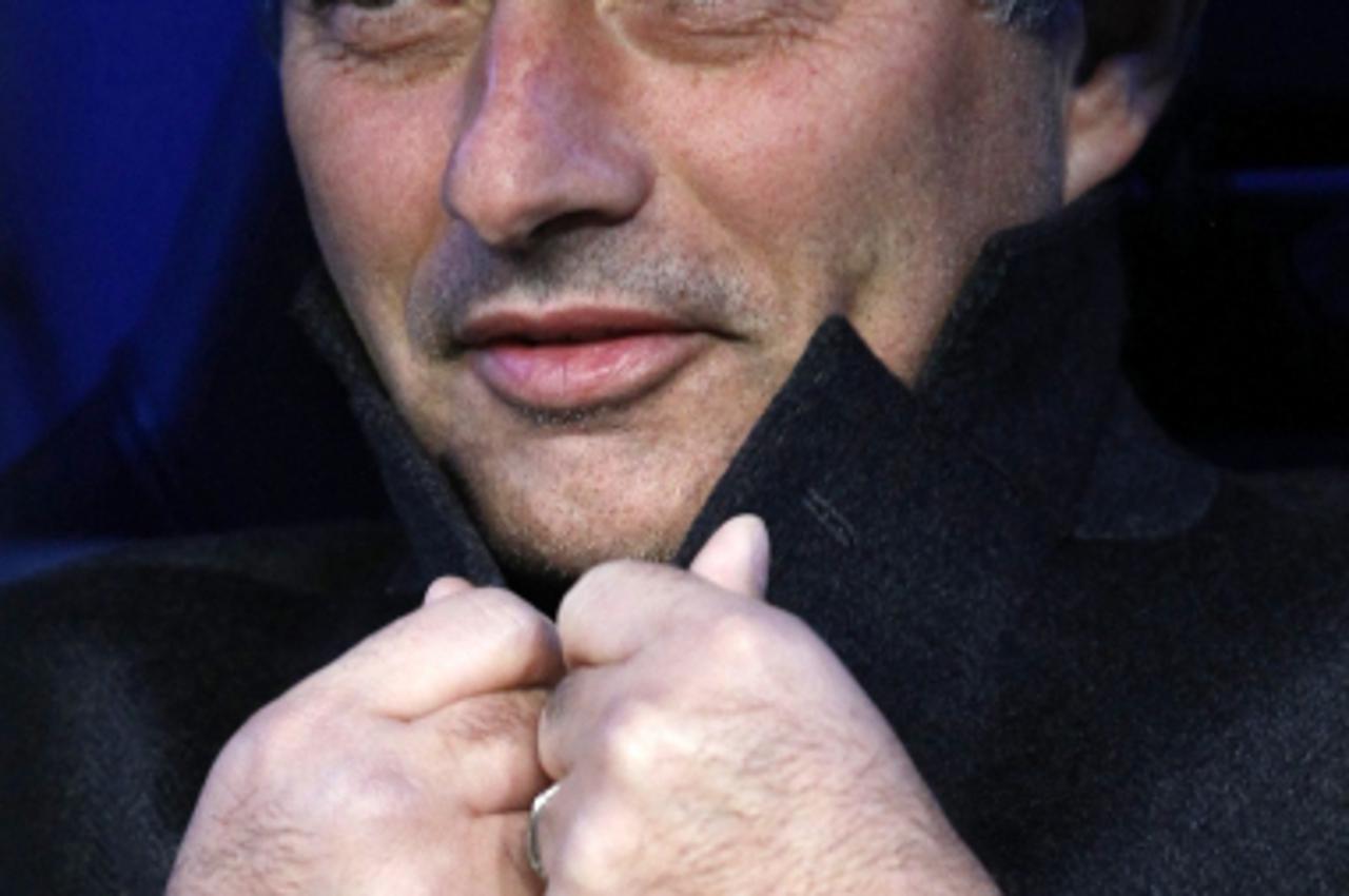 'Real Madrid\'s coach Jose Mourinho is seen before the start of their Spanish first division soccer match against Valencia at the Santiago Bernabeu stadium in Madrid, December 4, 2010. REUTERS/Juan Me