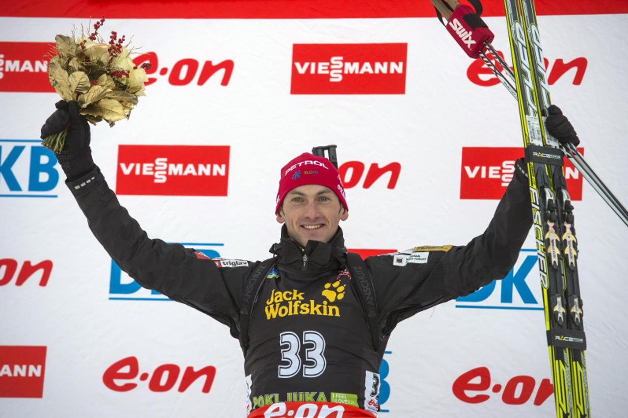 'Slovenia's Jakov Fak celebrates his first place on the podium of an IBU World Cup Biathlon 10 km Men Sprint in Pokljuka, Slovenija, on December 13, 2012.  AFP PHOTO / JURE MAKOVEC'