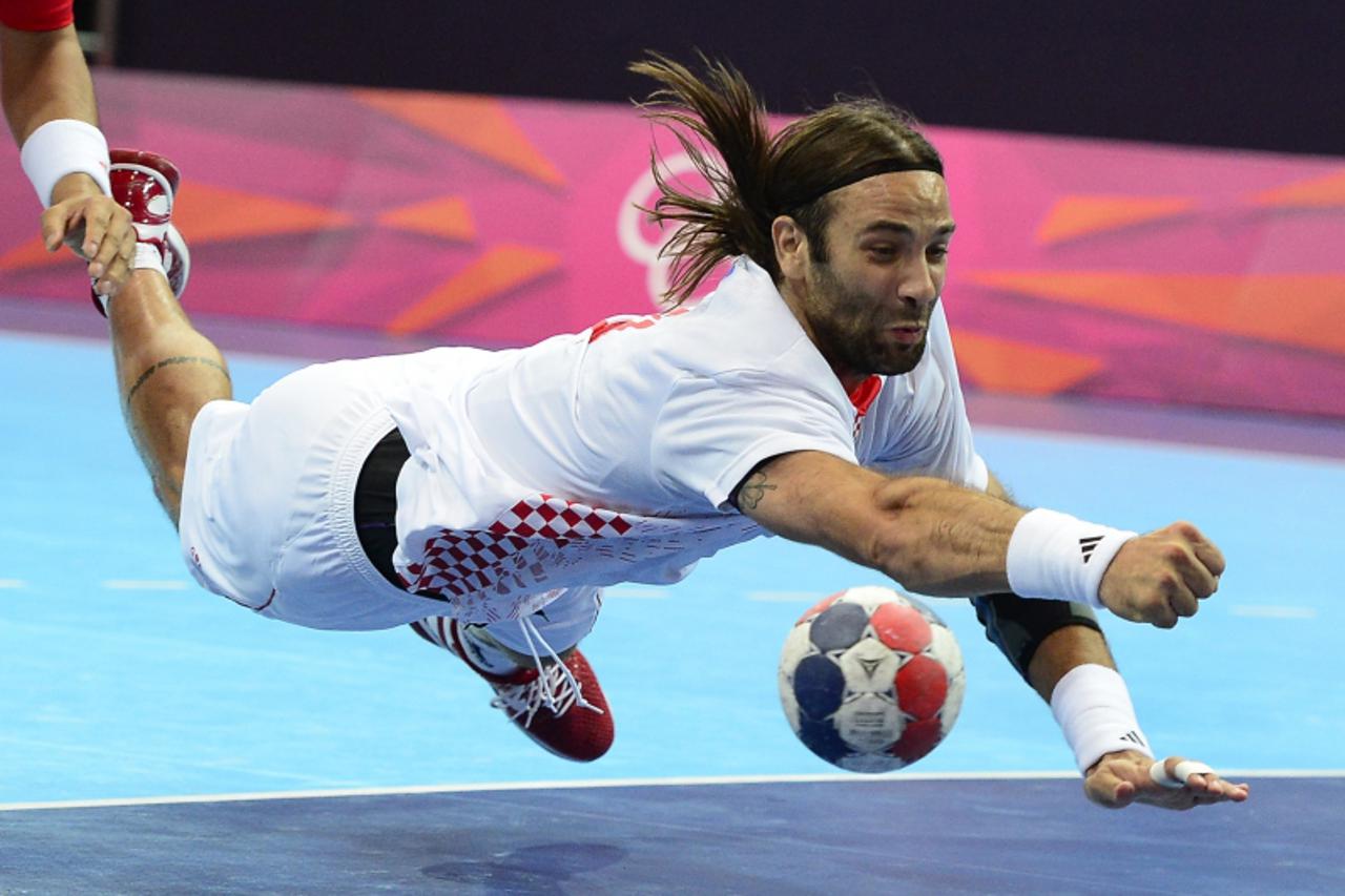 'Croatia\'s centreback Ivano Balic dives during the men\'s preliminaries Group B handball match Croatia vs South Korea for the London 2012 Olympics Games on July 29, 2012 at the Copper Box hall in Lon