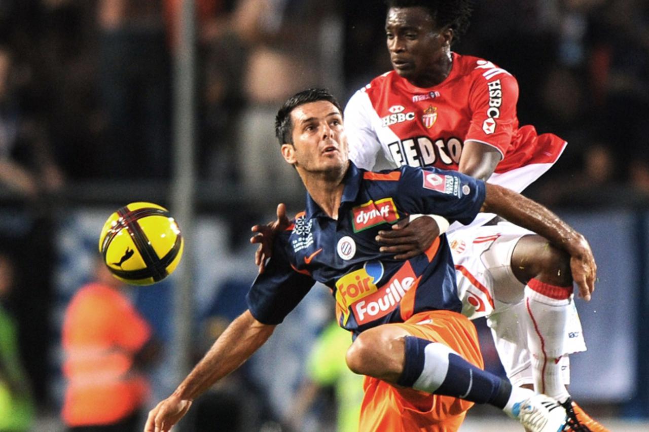 \'Montpellier\'s defender Emir Spahic (L) vies with Monaco\'s forward Benjamin Moukandjo (R) during the French L1 football match Montpellier vs Monaco, on May 21, 2011 at the Mosson stadium in Montpel