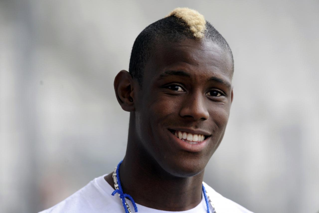 'CAPTION CORRECTION - CORRECTING IDENTITY   Enoch Balotelli, brother of Italy\'s national team player Mario Balotelli, smiles as he observes a training session during the EURO 2012 soccer tournament i