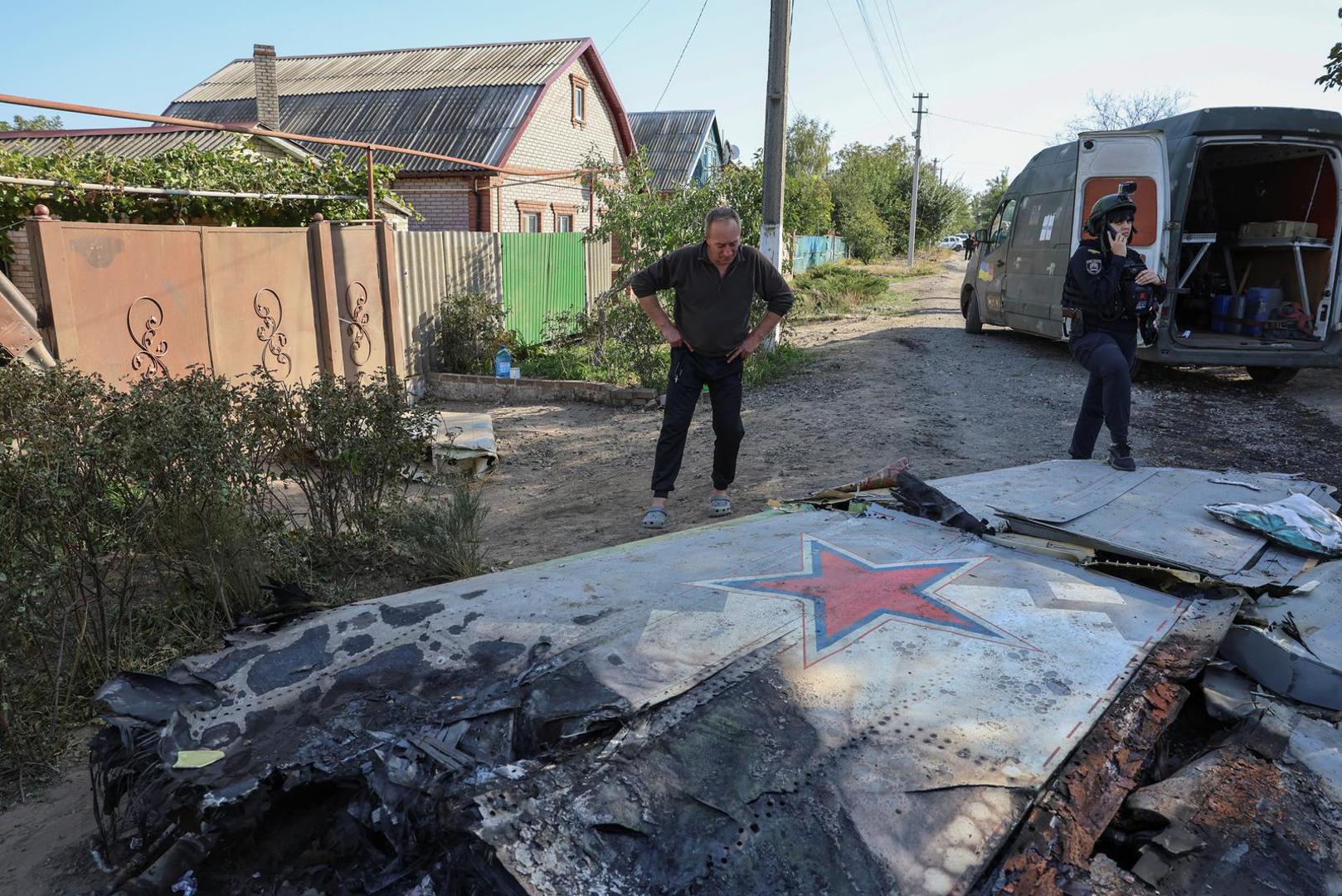 A local man looks at a part of a Russian aerial vehicle, which local authorities assume to be a newest heavy unmanned aerial vehicle S-70 Okhotnik (Hunter) or variation of Sukhoi fighting jet, is seen in residential area of the town of Kostintynivka after it was shot down, amid Russia's attack on Ukraine, in Donetsk region, Ukraine October 5, 2024.  Radio Free Europe/Radio Liberty/Serhii Nuzhnenko via REUTERS Photo: RFE/RL/SERHII NUZHNENKO/REUTERS