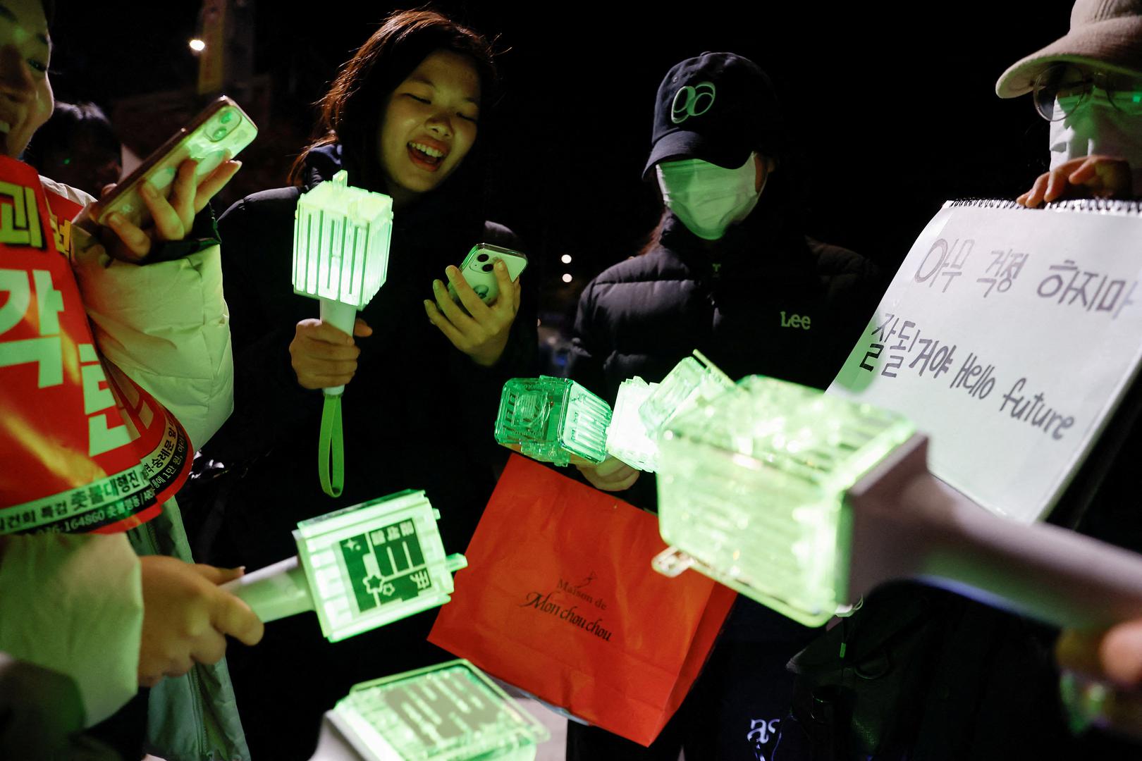 FILE PHOTO: Fans of K-pop boy band NCT sing one of their songs while holding light sticks, as they attend a protest rally calling for the impeachment of South Korean President Yoon Suk Yeol, who declared martial law, which was reversed hours later, near the National Assembly in Seoul, South Korea, December 8, 2024. REUTERS/Kim Soo-hyeon/File Photo Photo: KIM SOO-HYEON/REUTERS