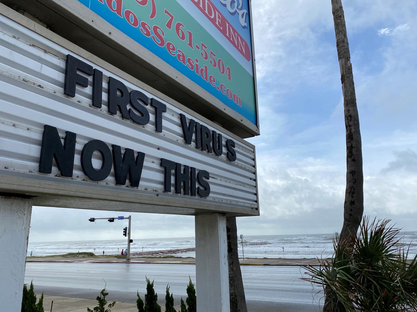 Hurricane Laura approaches A sign referencing the coronavirus disease (COVID-19) and Hurricane Laura is seen in Galveston, Texas, U.S., August 26, 2020. REUTERS/Julio-Cesar Chavez JULIO CESAR CHAVEZ