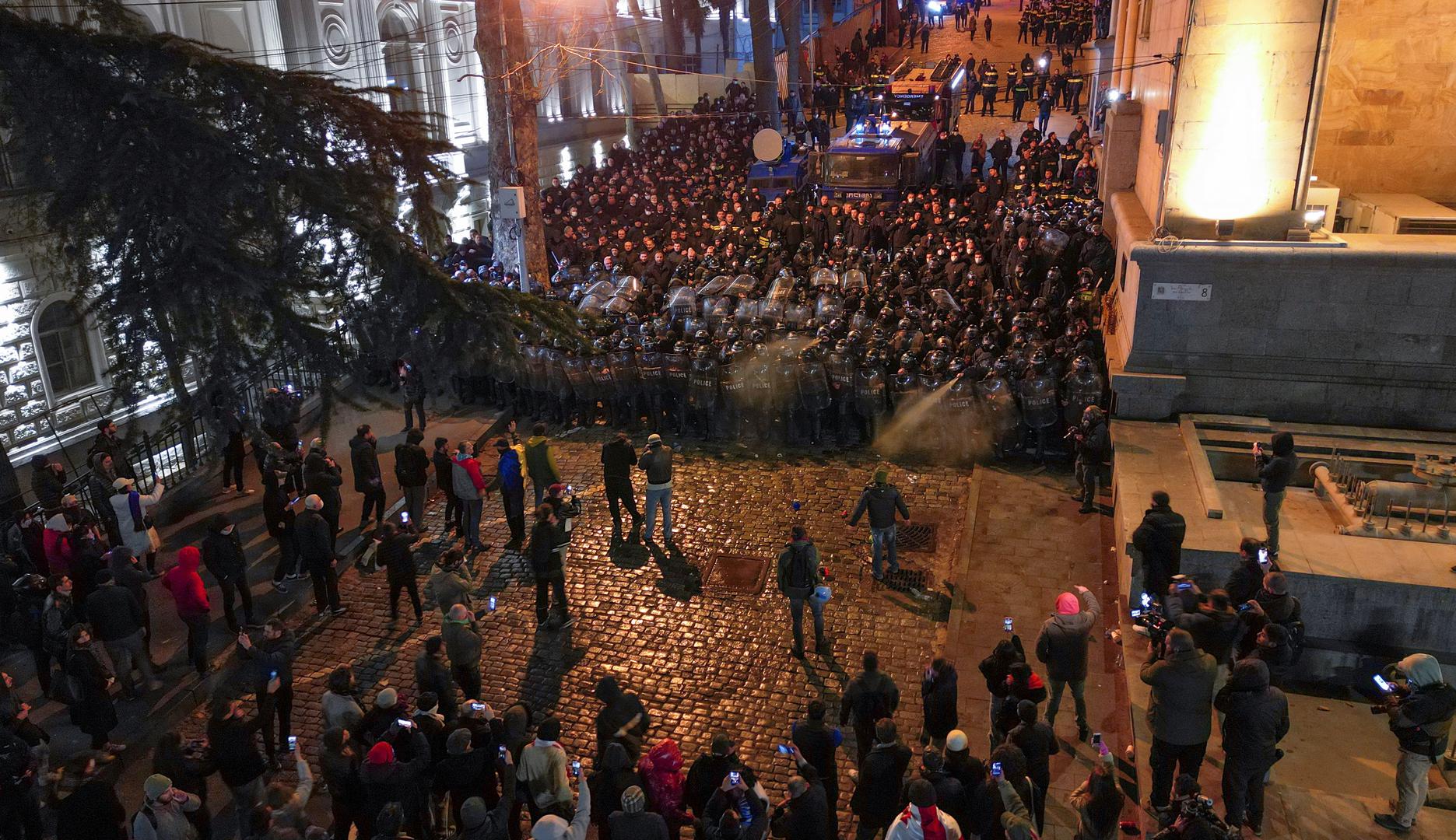 Protesters gather in front of police officers, who block the way during a rally against the "foreign agents" law in Tbilisi, Georgia, March 7, 2023. REUTERS/Zurab Javakhadze Photo: ZURAB JAVAKHADZE/REUTERS