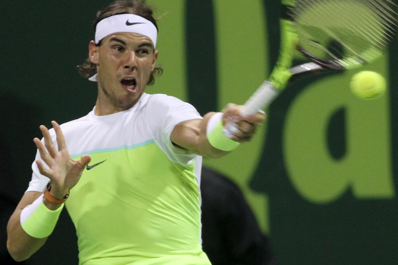 Rafael Nadal of Spain returns the ball to Robin Haase of the Netherlands during their Qatar Open men's singles tennis match in Doha, Qatar January 6, 2016. REUTERS/Naseem Zeitoon