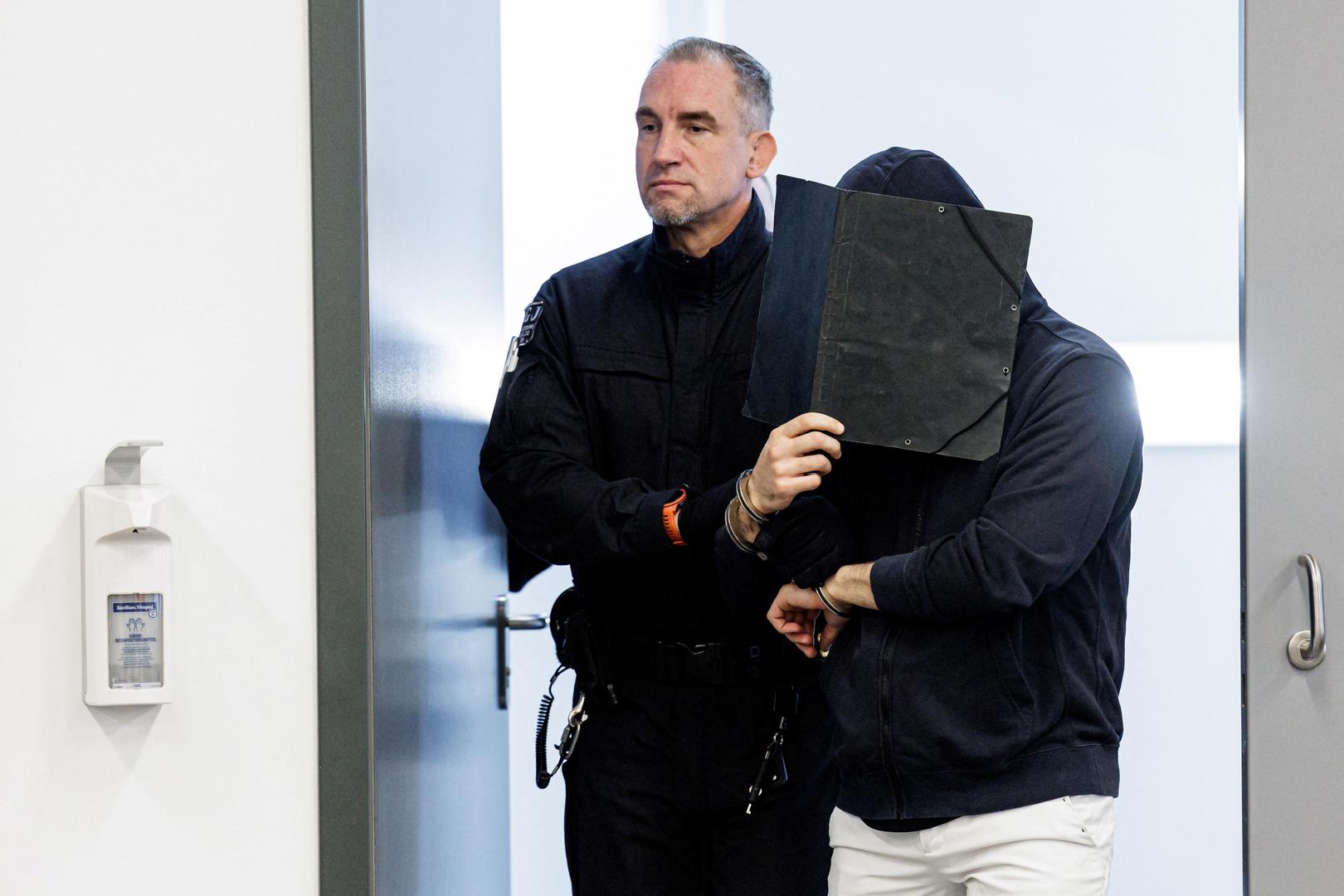 Defendant Ahmed R. is led in handcuffs by a judicial officer into the courtroom of the Higher Regional Court prior to a hearing in the trial over a November 2019 jewellery heist on the Green Vault (Gruenes Gewoelbe) museum in Dresden's Royal Palace, in Dresden, Germany, March 20, 2023. Jens Schlueter/Pool via REUTERS Photo: POOL/REUTERS