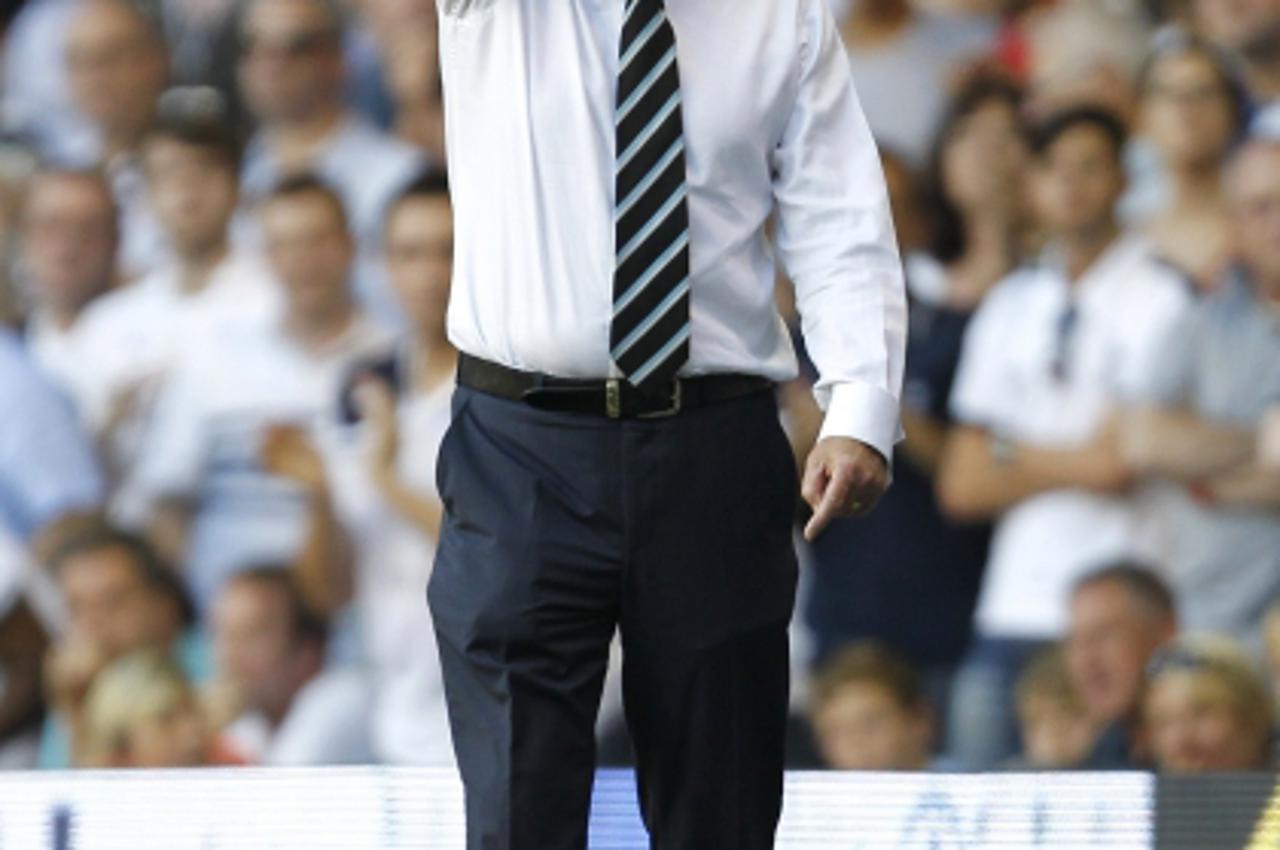 'Manager of Tottenham Hotspur Harry Redknapp  gestures  during an English Premier League football match between Tottenham Hotspur and Arsenal at White Hart Lane in London,  England, on October 2, 2011