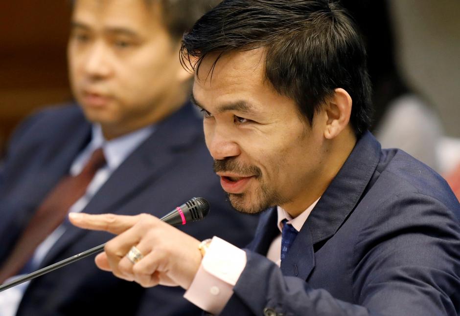 FILE PHOTO: Pacquiao questions Lascanas during a Senate inquiry on alleged extra judicial killings, in Manila