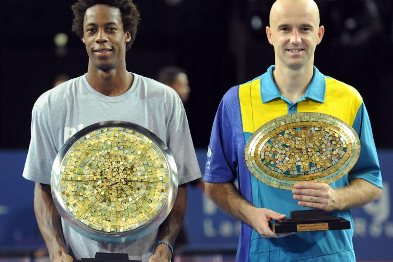 'France\'s Gael Monfils (L) poses with his trophy after beatinghis Croatian opponent Ivan Ljubicic (R) during the Montpellier world tour ATP Series final tennis match, on october 31, 2010 in Montpelli