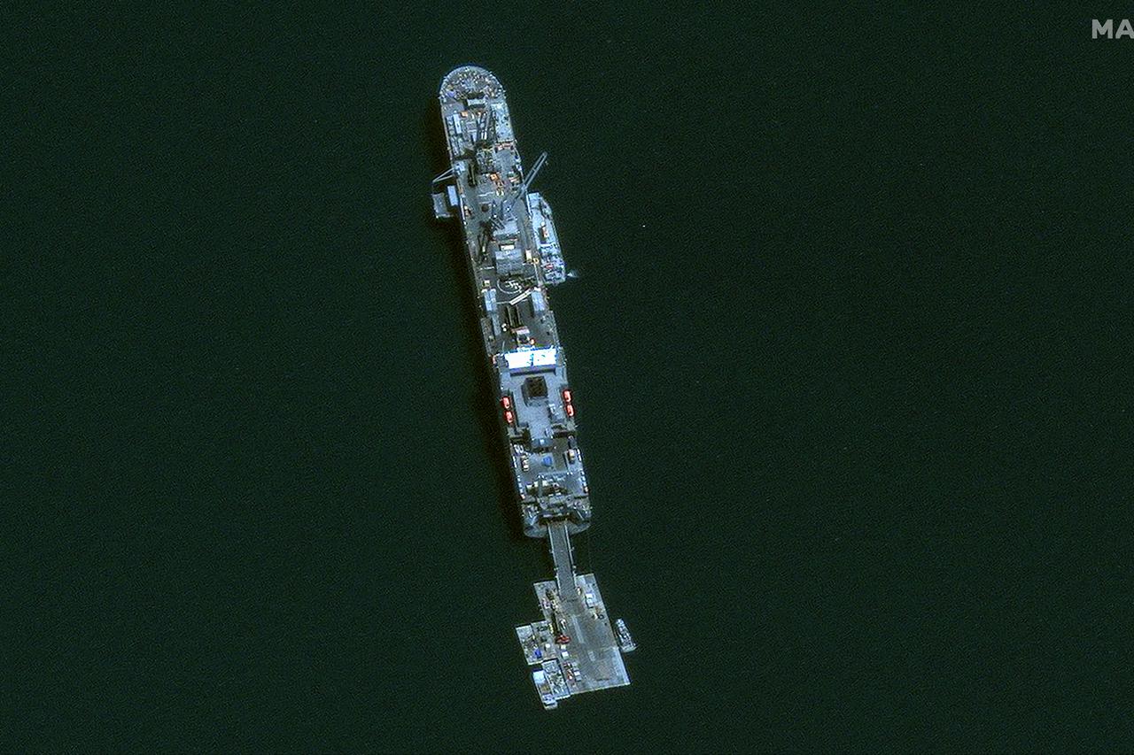 A satellite view of the MV Roy. P Benavidez delivering aid supplies to a floating dock, offshore Gaza