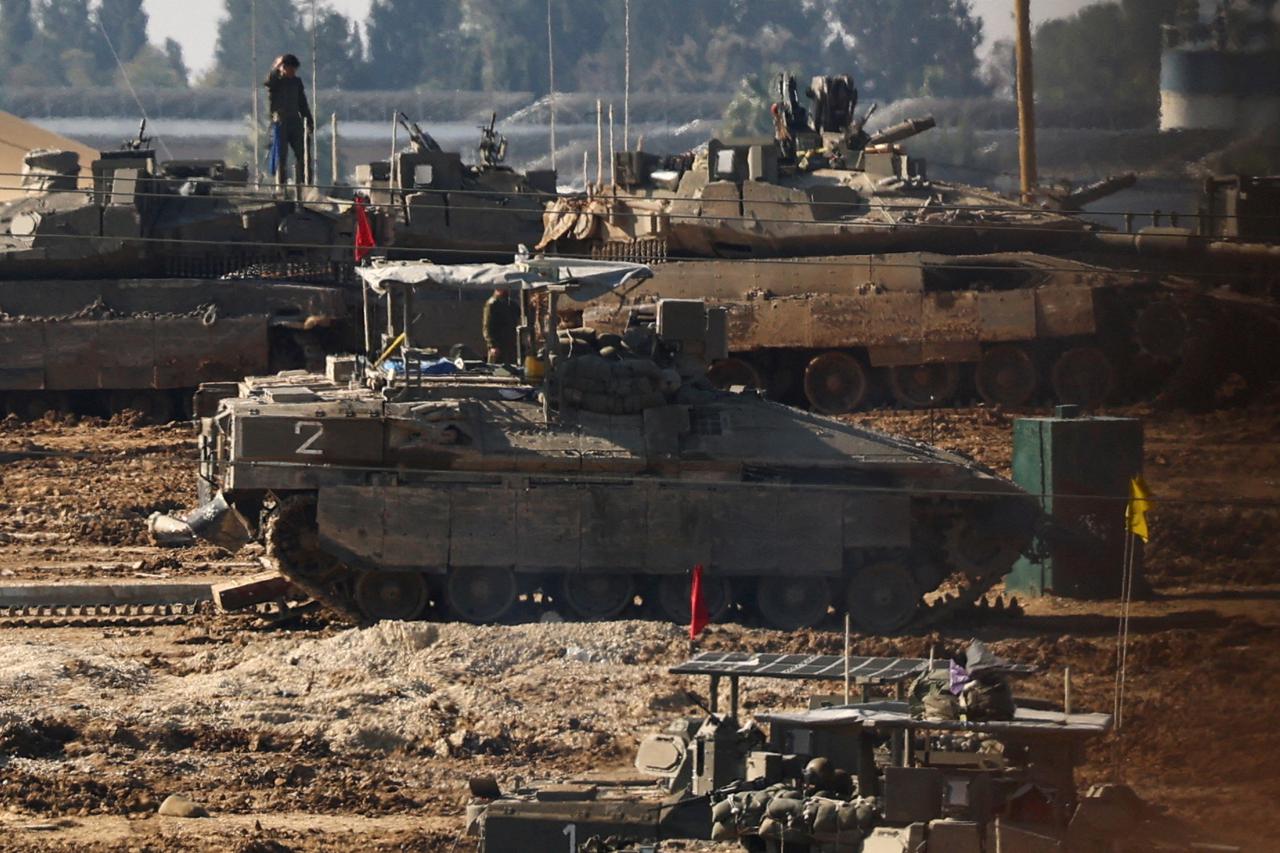 FILE PHOTO: Israeli military vehicles operate on a base near the border to Gaza, amid the ongoing conflict between Israel and Hamas, as seen from southern Israel