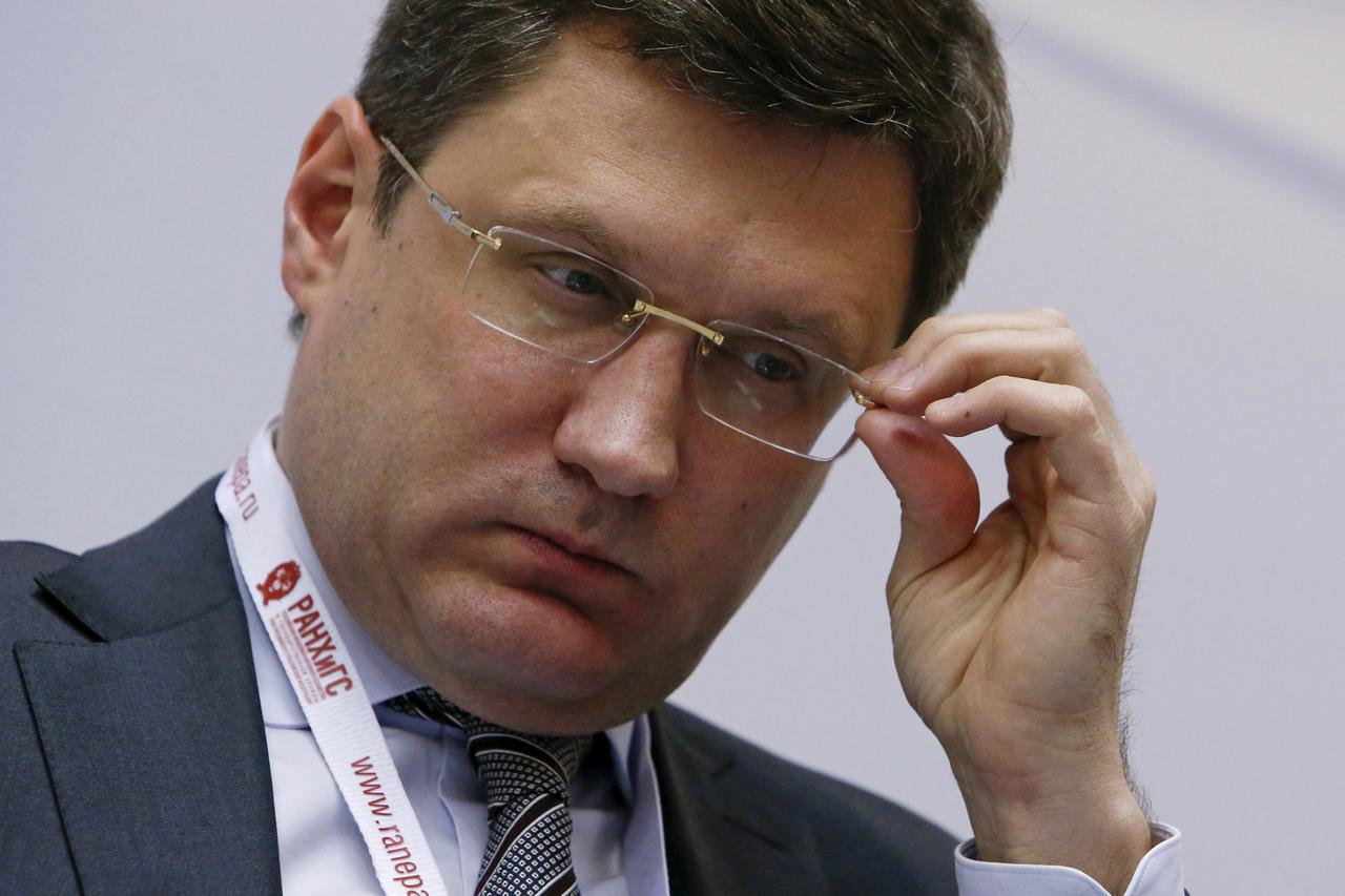 Russian Energy Minister Alexander Novak adjusts his glasses during a session of the Gaidar Forum 2016 