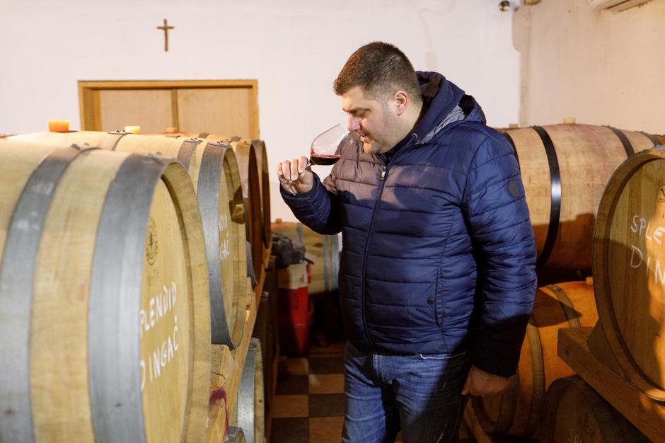 Boris Mrgudic tastes Benmosche Dingac wine in a vinery in Potomje