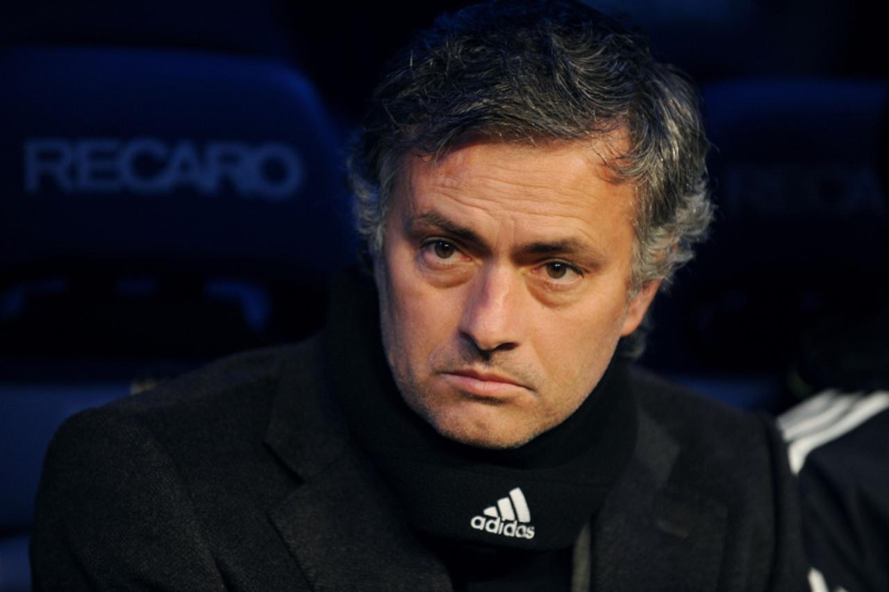 'Real Madrid\'s Portuguese coach Jose Mourinho looks on as he attends the Spanish league football match Real Madrid CF vs Real Sociedad on February 6, 2011 at the Santiago Bernabeu stadium in Madrid. 