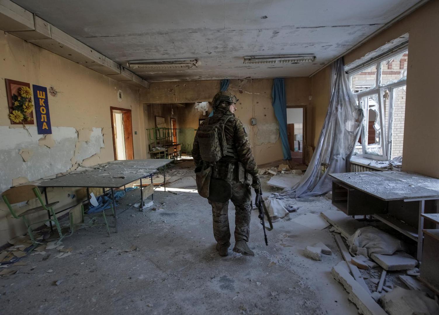 A Ukrainian serviceman is seen in a destroyed building of a school at a frontline, amid Russia's attack on Ukraine, in Donetsk region, Ukraine January 7, 2023. REUTERS/Anna Kudriavtseva Photo: Stringer/REUTERS