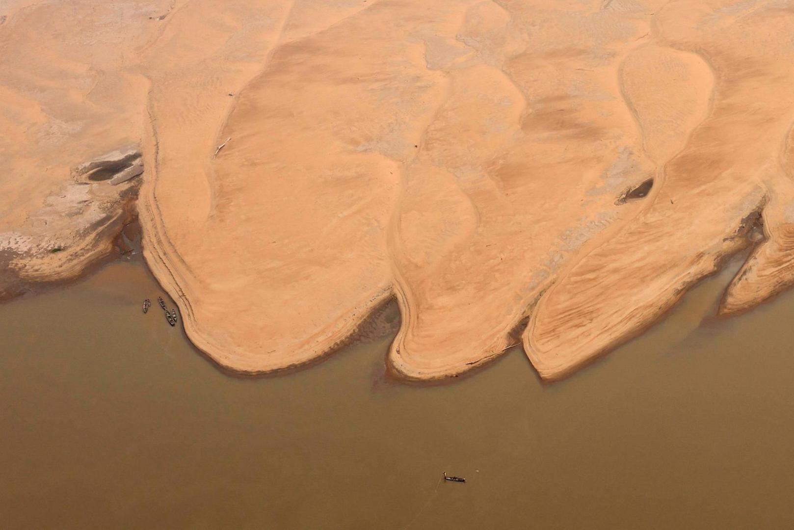 Boats are seen in front of the sandbanks at the Solimoes River, one of the largest tributaries of the Amazon River, during a Greenpeace flyover to inspect what the National Center for Monitoring and Early Warning of Natural Disasters (Cemaden) says is the most intense and widespread drought Brazil has experienced since records began in 1950, near Tefe, Amazonas state, Brazil September 17, 2024. REUTERS/Jorge Silva Photo: JORGE SILVA/REUTERS