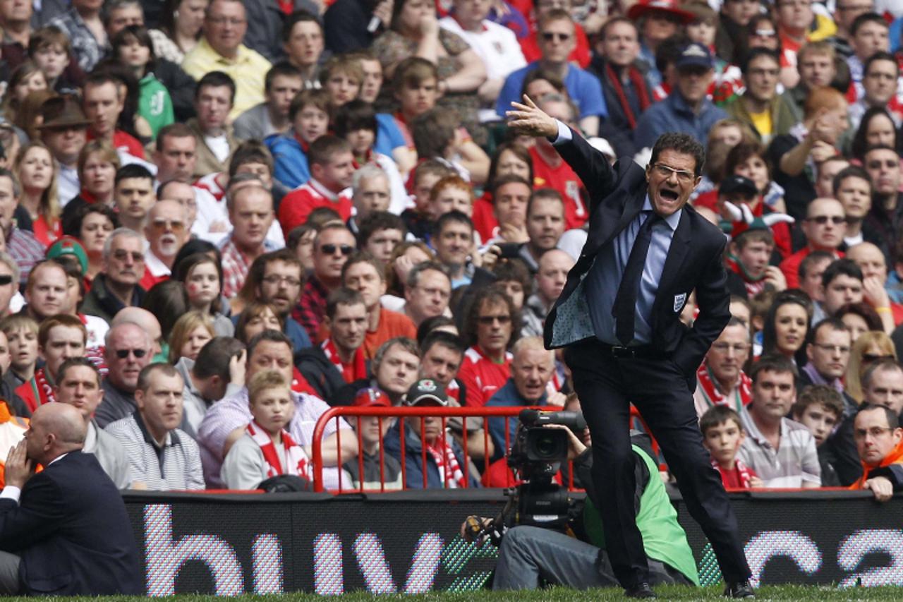 'England\'s coach Fabio Capello gestures during their Euro 2012 Group G qualifying soccer match against Wales at the Millennium Stadium in Cardiff, south Wales, March 26, 2011. REUTERS/Stefan Wermuth 