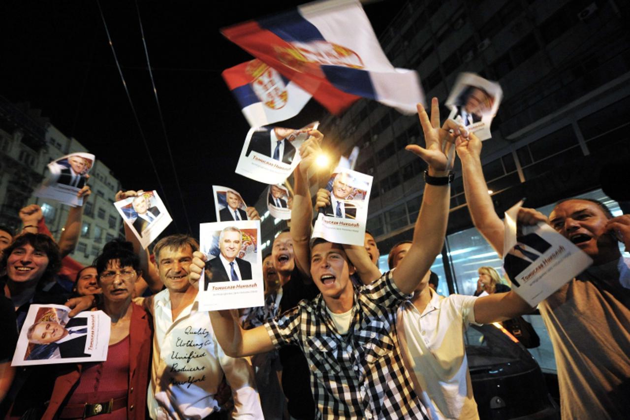 'Supporters of Serbia\'s newly elected President and leader of Serbian Progressive Party (SNS), Tomislav Nikolic, celebrate his victory in the presidential run-off, in downtown Belgrade on May 20, 201