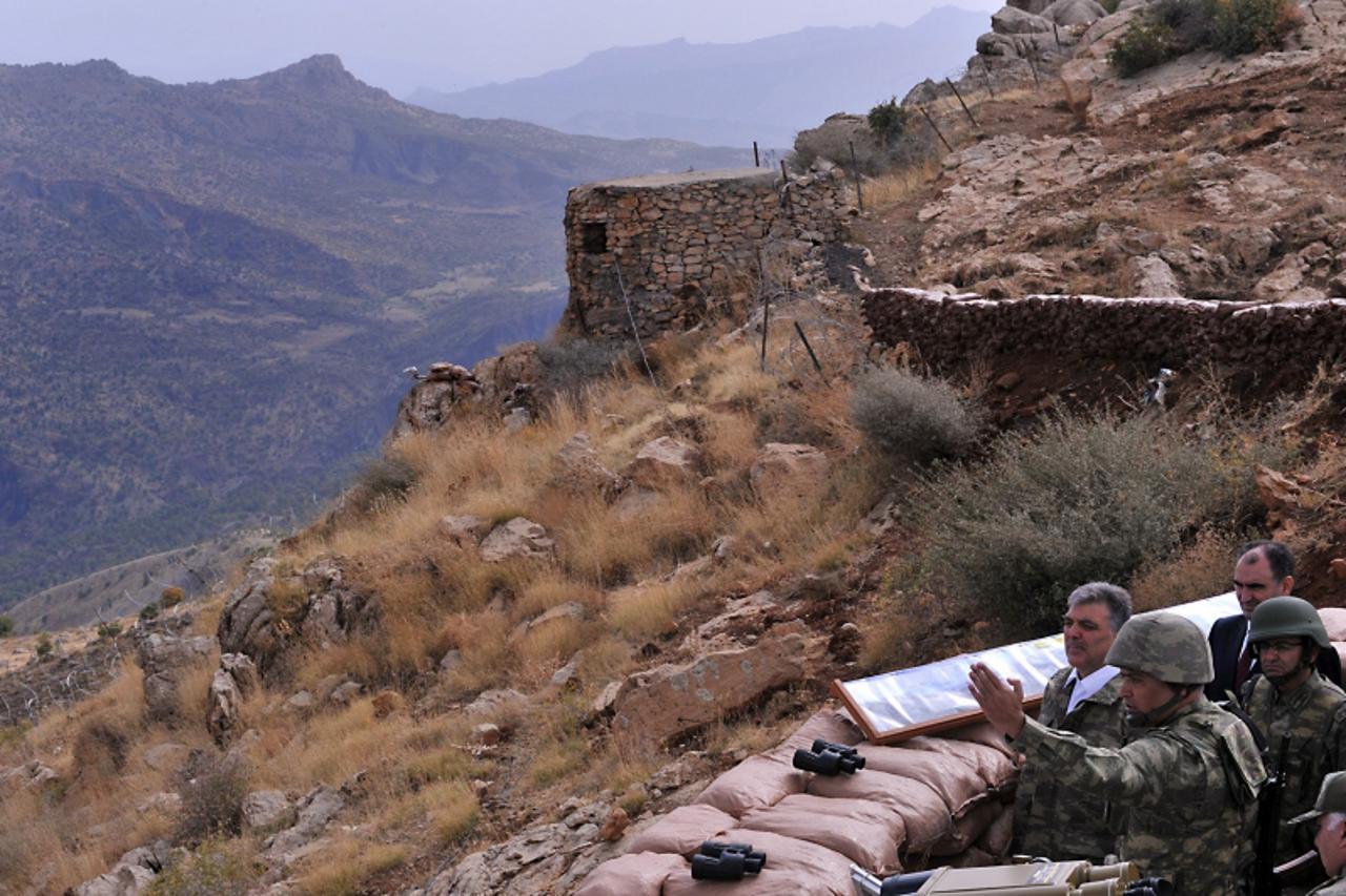 'Turkey\'s President Abdullah Gul (3rd R) listens to an army officer at a military post during his visit to troops in the Hakkari province in southeastern Turkey on the Turkish-Iraqi border, October 1