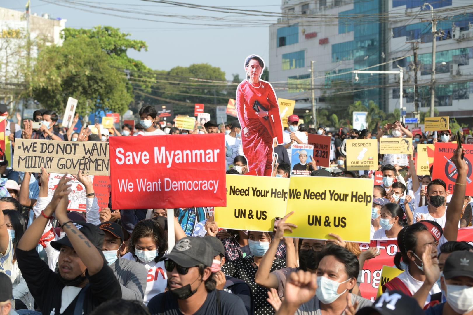 Protest against the military coup, in Yangon Demonstrators hold placards and a cutout with the image of Aung San Suu Kyi during a protest against the military coup in Yangon, Myanmar, February 15, 2021. REUTERS/Stringer STRINGER