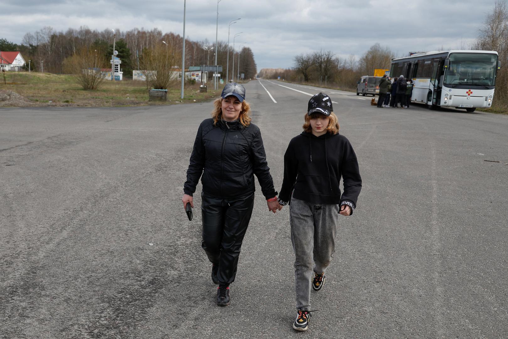 Iryna Hrinchenko smiles as she walks with her daughter Anastasiia, who went to a Russian-organised summer camp from non-government controlled territories and was then taken to Russia, after returning via the Ukraine-Belarus border, in Volyn region, Ukraine April 7, 2023. REUTERS/Valentyn Ogirenko Photo: VALENTYN OGIRENKO/REUTERS