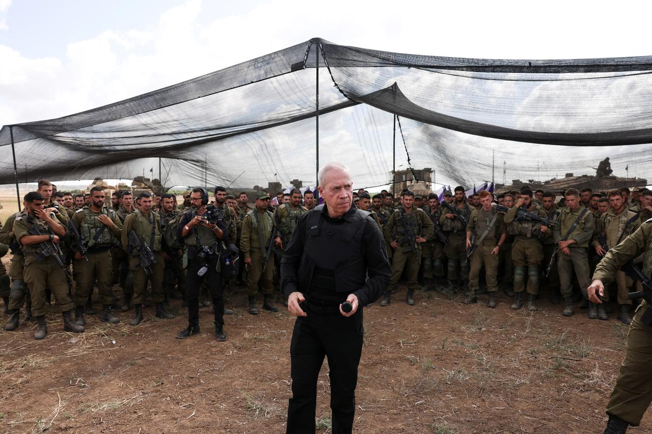 Israel's Defence Minister Yoav Gallant meets soldiers in a field near Israel's border with the Gaza Strip, in southern Israel