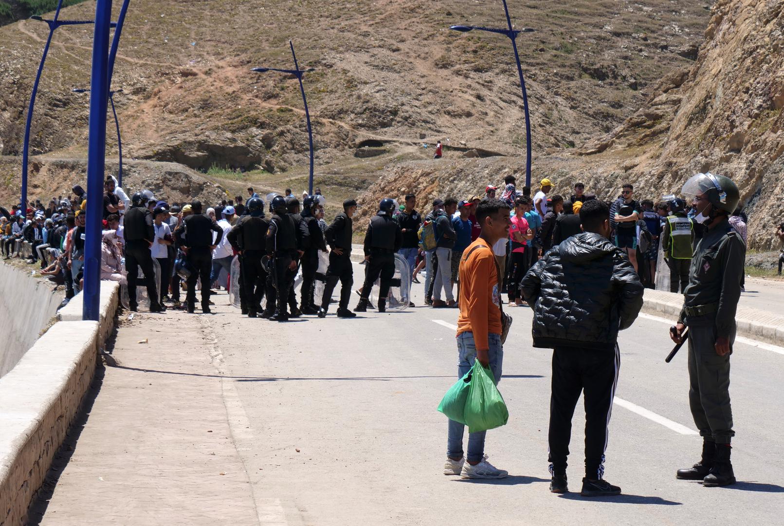 A police officer talks to migrant in Fnideq, close to the Spanish enclave Ceuta A police officer talks to migrant in Fnideq, close to the Spanish enclave Ceuta, in Morocco, May 19, 2021. REUTERS/Shereen Talaat SHEREEN TALAAT