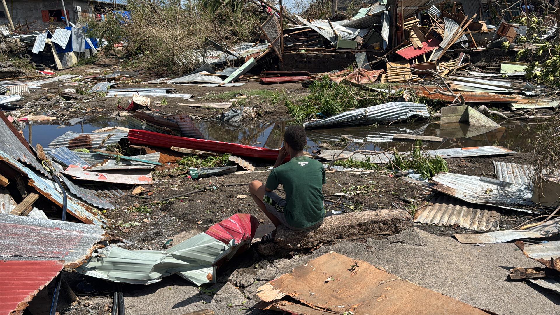 A boy sits near the ruins of homes, in the aftermath of the Cyclone Chido, within Labattoir in Mayotte, France, December 15, 2024. REUTERS/Chafion Madi REFILE - QUALITY REPEAT Photo: Chafion Madi/REUTERS