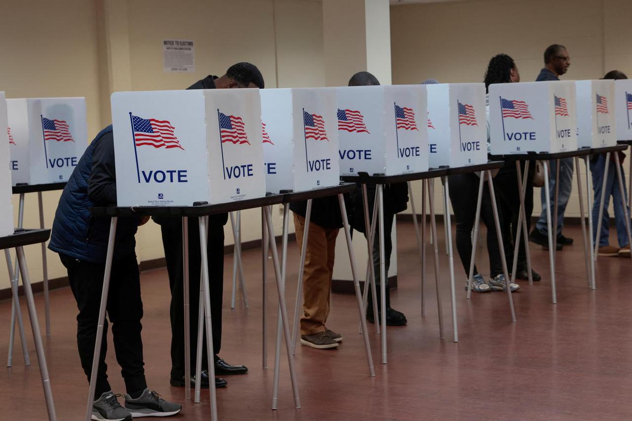 Voters cast their votes during early voting in the U.S. presidential election at a polling station in Detroit, Michigan,