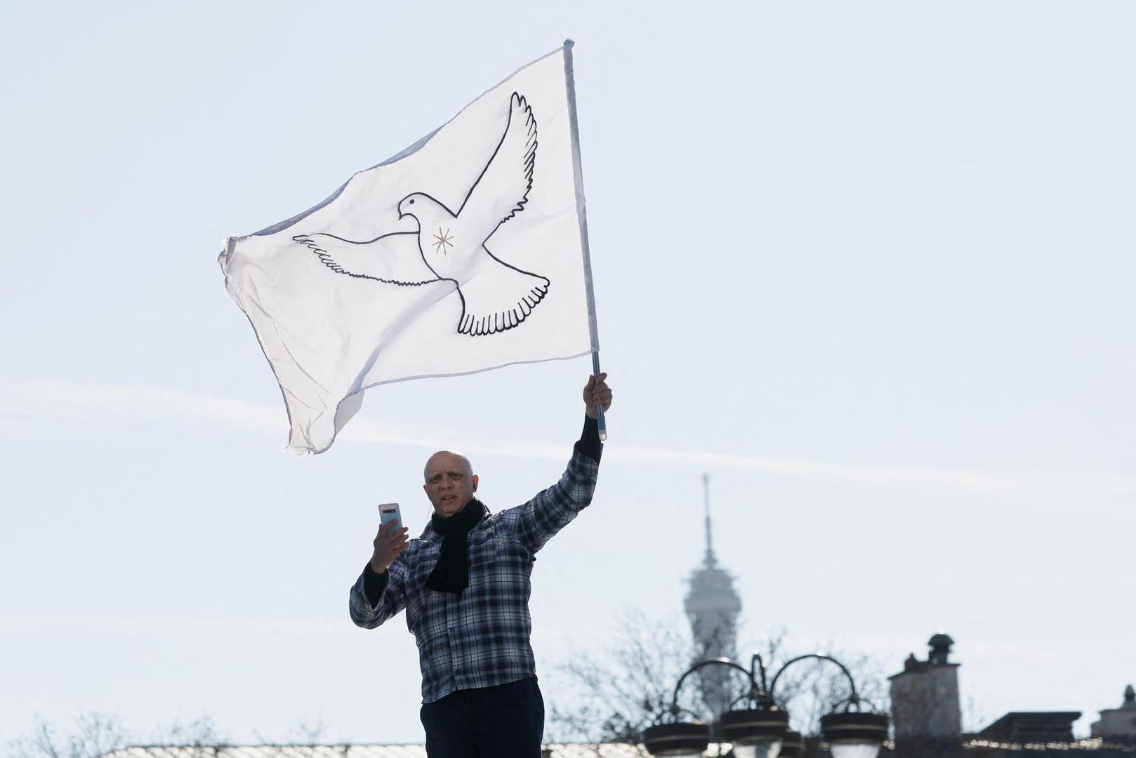 A protester stands atop a vehicle as cars parade during their "Convoi de la liberte" (The Freedom Convoy), a vehicular convoy to protest coronavirus disease (COVID-19) vaccine and restrictions, in Paris, France, February 12, 2022. REUTERS/Benoit Tessier Photo: BENOIT TESSIER/REUTERS