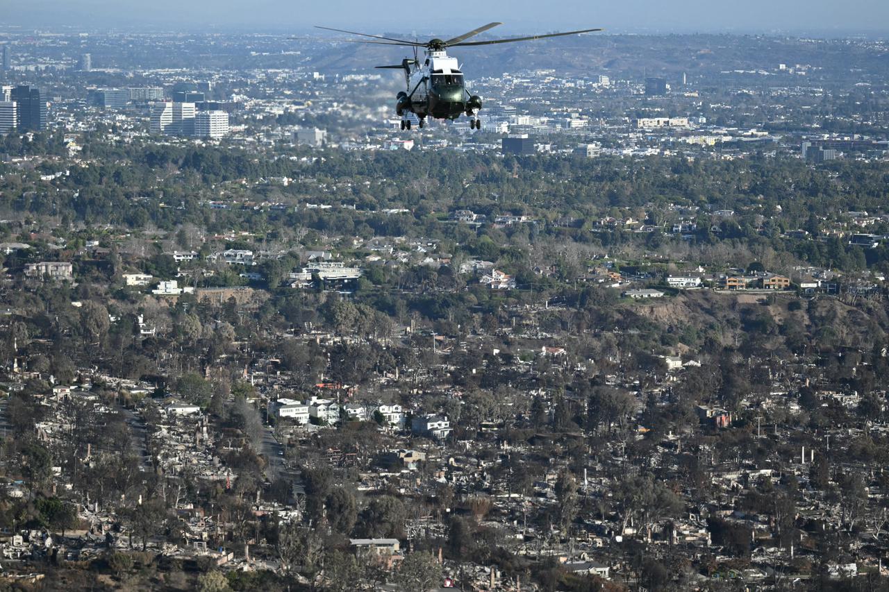 Marine One, carrying U.S. President Donald Trump, flies above devastation caused by wildfires around Los Angeles, California