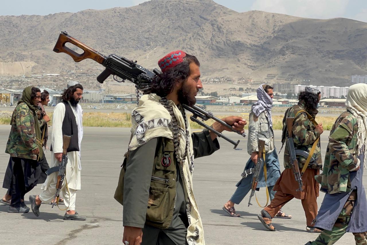 Taliban forces patrol at a runway a day after U.S troops withdrawal from Hamid Karzai International Airport in Kabul