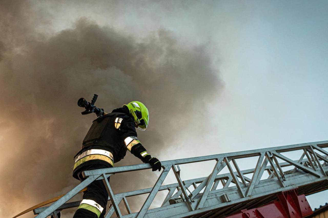 Firefighters work at the site of a damaged building amid Russia's attack on Ukraine, in Kharkiv