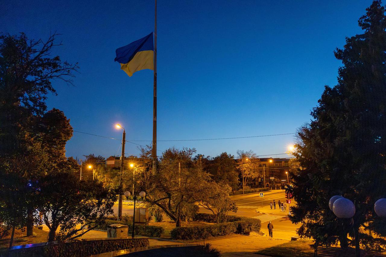 The Ukrainian national flag flies at half mast in Kharkiv to commemorate the victims of a missile attack in the village of Hroza during Russia's ongoing attack on Ukraine