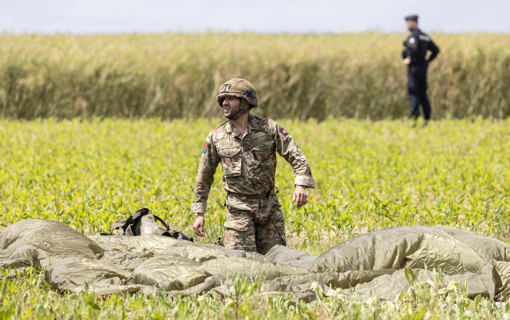 Paratroopers land in a field after making a commemorative jump into fields around the French village of Sanneville in Normandy as part of the 80th anniversary of D-day. 05.06.2024   Material must be credited "The Times/News Licensing" unless otherwise agreed. 100% surcharge if not credited. Online rights need to be cleared separately. Strictly one time use only subject to agreement with News Licensing Photo: Richard Pohle/NEWS SYNDICATION